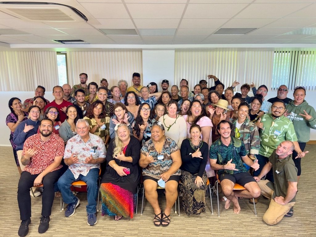 A large group of cohort participants smiling together